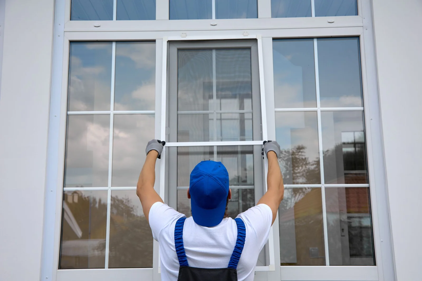 Window glass work at a white-framed residential window